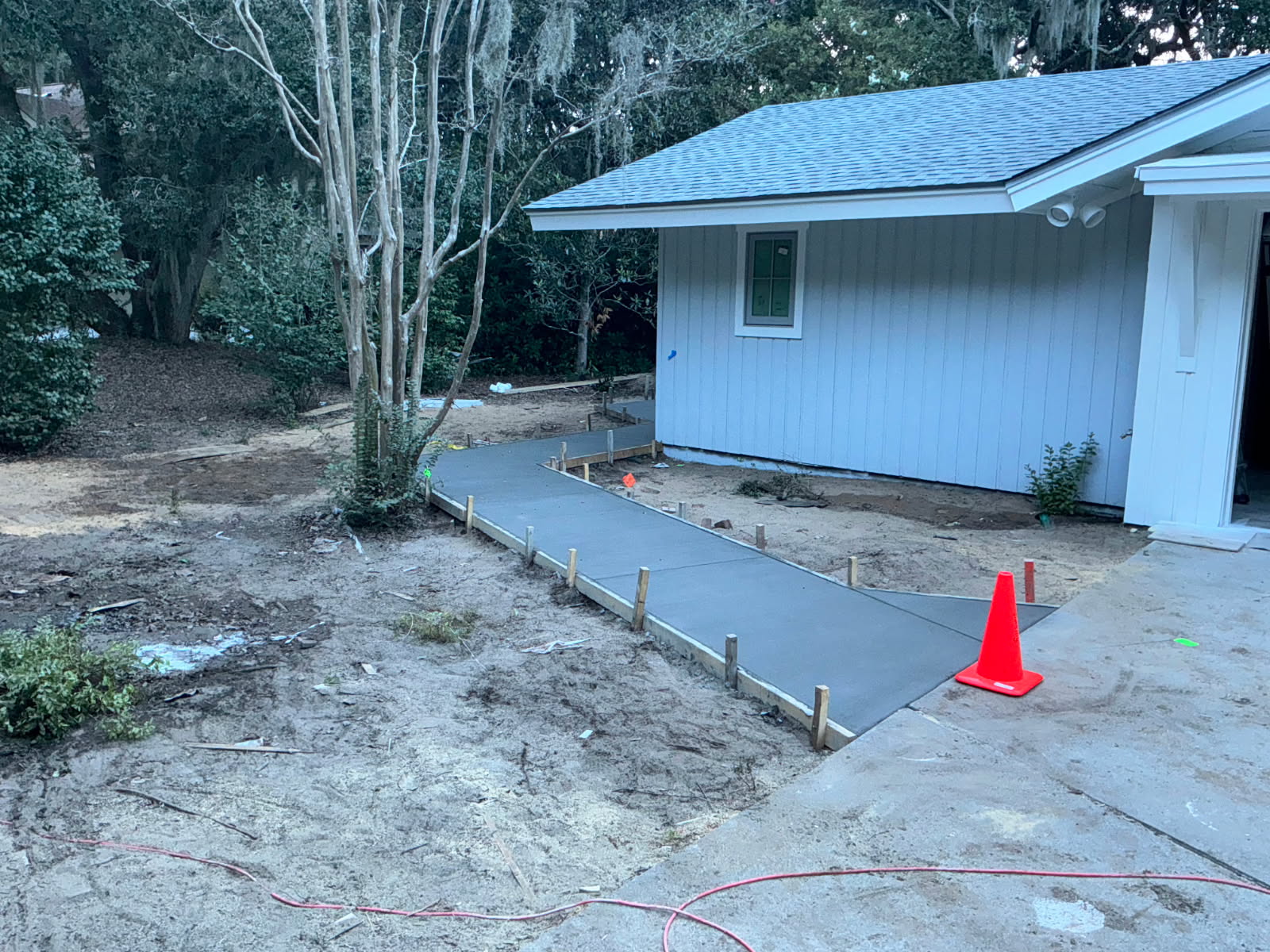 General contracting on site — a newly built Low Country home standing on its freshly graded, still-bare lot before the lawn goes in