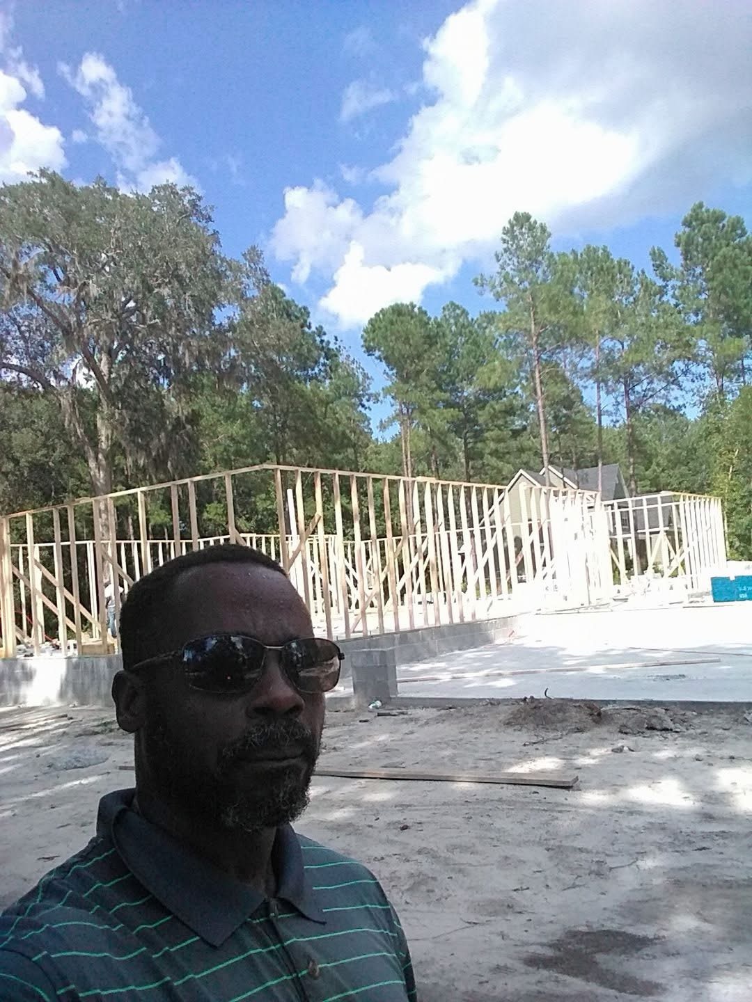 General contracting on site — the frame standing on the newly framed raised walls of a Low Country home
